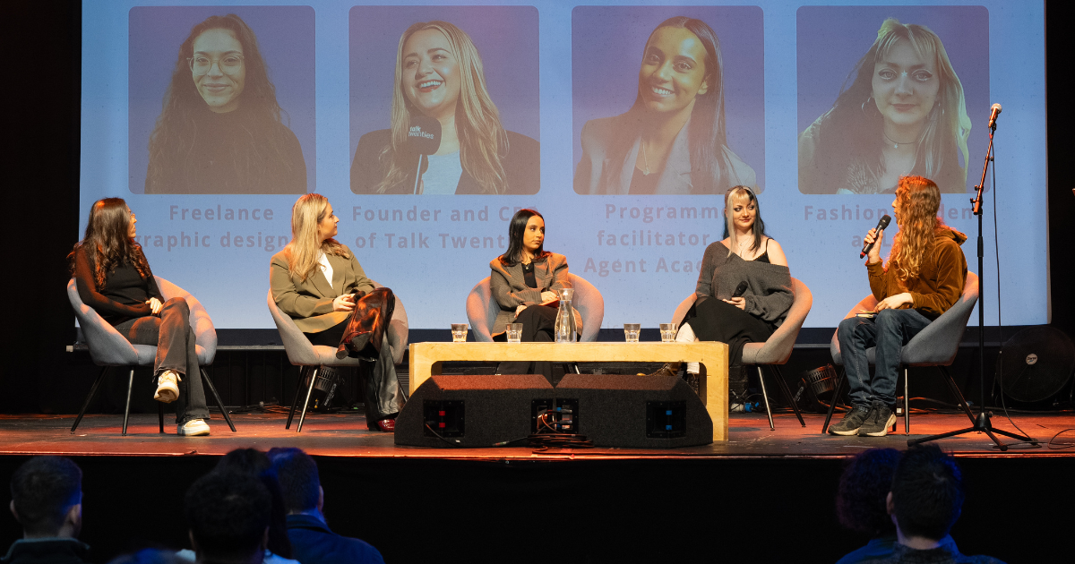 Wide shot of the next gen panel, showing speakers and the host